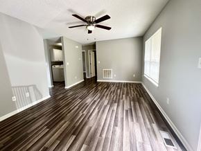 Anderson apartment for rent - A room with a ceiling fan and wooden flooring.