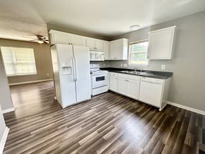 Anderson apartment for rent - A kitchen with white appliances and wooden floors.