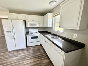 Anderson apartment for rent - A kitchen with white appliances and cabinets.