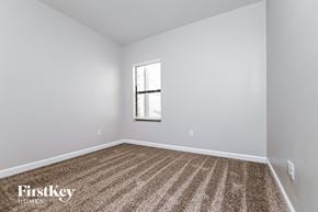 Riverview house for rent - a bedroom with white walls and carpet and a window