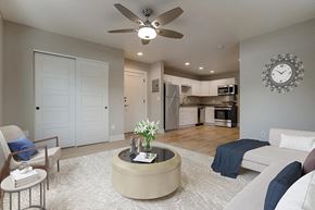 Denver apartment for rent - an open living room and kitchen with a large clock on the wall