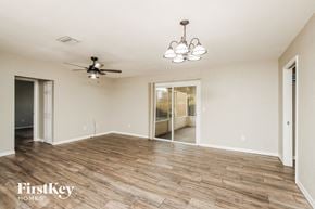Palm Bay house for rent - a living room with a wood floor and a ceiling fan