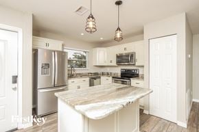 Palm Bay house for rent - a kitchen with stainless steel appliances and a marble counter top