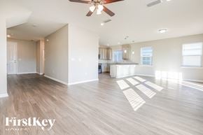 Jacksonville house for rent - A spacious room with a ceiling fan and wooden flooring.