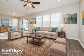 Jacksonville house for rent - A living room with a couch, chairs, and a coffee table.