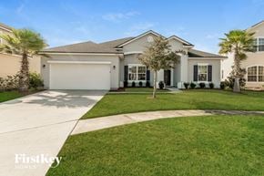 Jacksonville house for rent - a house with palm trees and a lawn