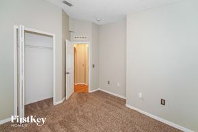 Sebastian house for rent - a bedroom with carpet and a door to a closet