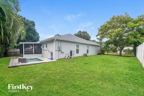 Sebastian house for rent - a white house with a yard and a pool