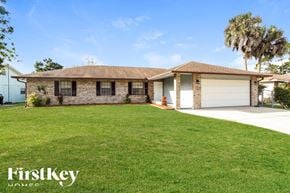Palm Bay house for rent - A house with a brown roof and a white garage door.