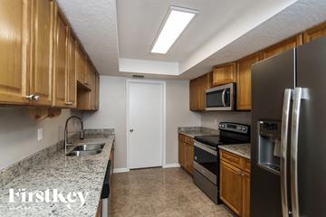 Palm Bay house for rent - A kitchen with wooden cabinets and a granite countertop.