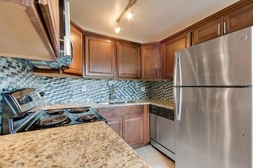 Denver apartment for rent - a kitchen with stainless steel appliances and granite counter tops