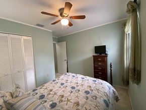 Bradenton house for rent - a bedroom with a bed and a ceiling fan