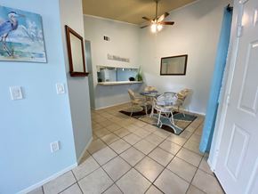 Bradenton house for rent - a dining area with a table and chairs and a ceiling fan
