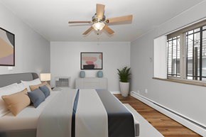 Denver apartment for rent - a bedroom with a large bed and a ceiling fan