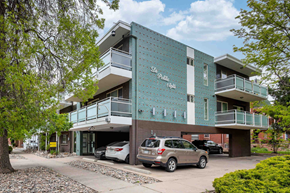 Denver apartment for rent - a building with a parking lot and cars in front of it
