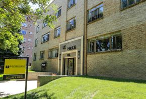 Denver apartment for rent - a large brick building with a sign in front of it