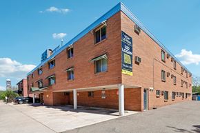 Denver apartment for rent - A large brick building with a blue roof and a sign that reads "Levant".