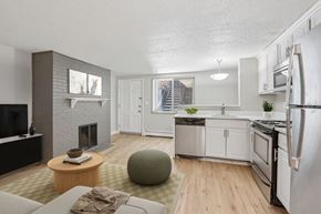 Denver apartment for rent - A modern kitchen with white appliances and a grey floor.