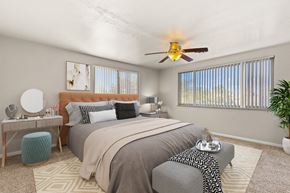 Denver apartment for rent - a bedroom with a large bed and a ceiling fan