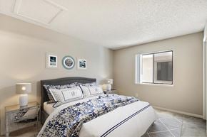 Denver apartment for rent - a bedroom with a bed and a window
