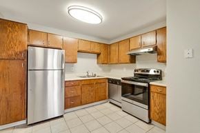 Denver apartment for rent - a kitchen with stainless steel appliances and wooden cabinets