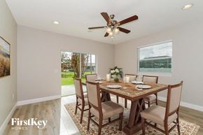 Cape Coral house for rent - A dining room with a wooden table set for four.