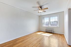 Denver apartment for rent - A bedroom with a bed, nightstand, and window.