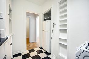 Denver apartment for rent - A black and white checkered floor in a white kitchen.