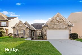 Concord house for rent - a brick and stone house with a white garage door