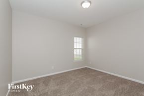 Concord house for rent - a bedroom with a carpeted floor and a window