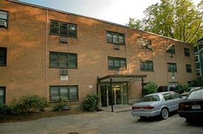Brookline apartment for rent - a brick building with cars parked in front of it