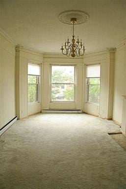 Brookline apartment for rent - an empty living room with a chandelier