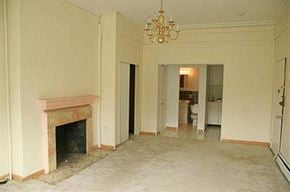 Brookline apartment for rent - an empty living room with a fireplace and a chandelier