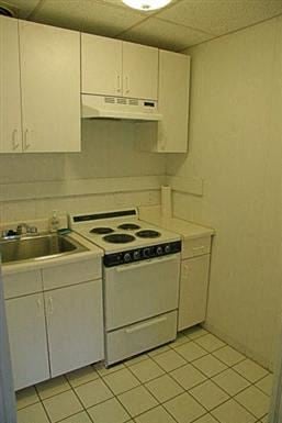 Brookline apartment for rent - a small kitchen with a stove and a sink