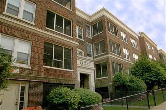 Brighton apartment for rent - a brick building with a chain link fence in front of it