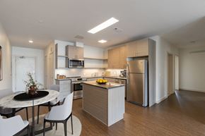 Newton apartment for rent - a kitchen and dining room with stainless steel appliances and a table