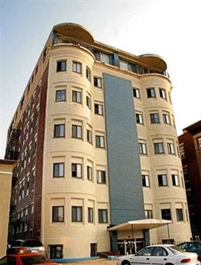 Allston apartment for rent - a tall building with a car parked in front of it