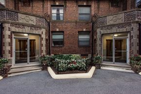 Somerville apartment for rent - the front of a brick apartment building with a courtyard