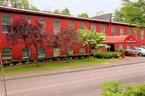 Northborough apartment for rent - a red building with trees in front of a street