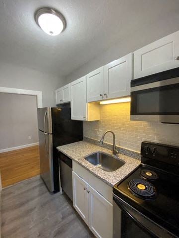Worcester apartment for rent - a kitchen with a sink and a stove and a refrigerator