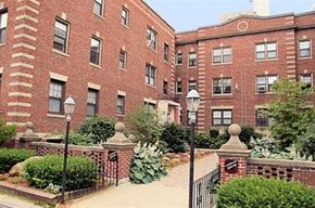 Worcester apartment for rent - a red brick building with a garden in front of it