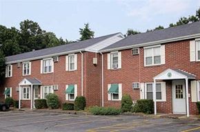 Westfield apartment for rent - a red brick apartment building with a parking lot