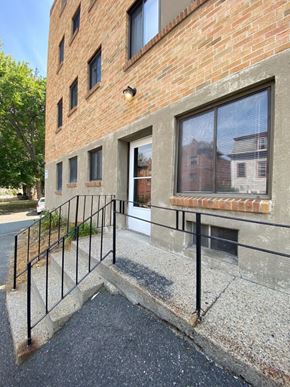 Worcester apartment for rent - the front entrance of a brick building with black railings