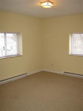 Worcester apartment for rent - an empty living room with two windows and a carpet