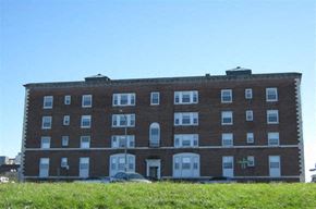 Worcester apartment for rent - a large brick building with cars in front of it