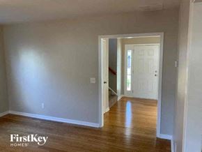 Stone Mountain house for rent - an empty living room with wood floors and a white door