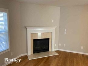 Stone Mountain house for rent - a living room with a fireplace and a wooden floor