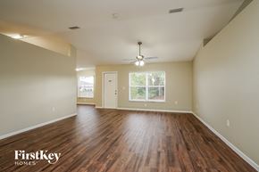 Cape Coral house for rent - the spacious living room with hardwood flooring and a ceiling fan
