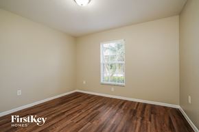 Cape Coral house for rent - the spacious living room with hardwood flooring and a window