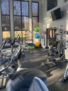 Johnston apartment for rent - a gym with treadmills and other exercise equipment in a building with windows